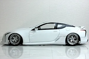 Side profile view of a white Pandora RC Lexus LC 7800 body shell fitted to a radio-controlled drift car with custom chrome wheels.