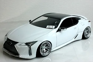 Pandora RC Lexus LC 7800 white body shell with black roof and custom wheels on a studio surface.
