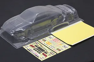Unpainted clear polycarbonate RC drift car body shell with window masks and decal sheet on a dark background.
