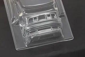 Unpainted clear polycarbonate RC car body shell showing front bumper and accessories molded into the sheet.