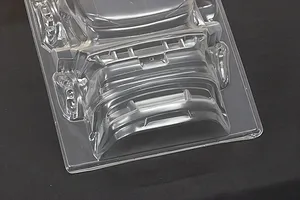 Unpainted clear polycarbonate RC car body shell parts molded on a sheet, set against a dark background.