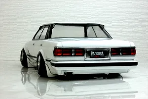 Rear view of a white RC drift car body showing detailed tail lights, bumper, exhaust, and Pandora RC license plate against a textured background.