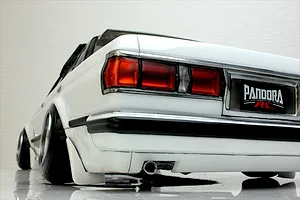 Rear low angle view of a white Pandora RC Toyota Mark 2 GX71 body shell featuring realistic taillights, chrome trim, and wide stance drift wheels.