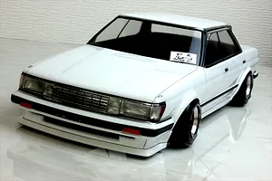 Painted white Toyota Mark 2 GX71 RC drift car body shell mounted on a chassis with custom wheels against a tiled background.