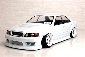 White Toyota Chaser RC drift car body shell on a studio table with white textured background