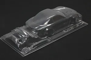 Unpainted clear polycarbonate RC car body shell for a Mazda RX-7 FD3S shown from a high rear angle on a dark background.