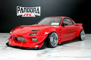 Red Pandora RC Mazda RX-7 FD3S RC drift car body shell on a marble surface with Pandora RC logo backdrop.