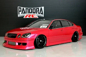 Red Pandora RC Toyota Aristo JZS161 drift body shell on a display floor with a Pandora RC logo backdrop.