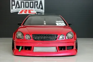 Front view of a red RC drift car body shell with Pandora RC logo in the background.
