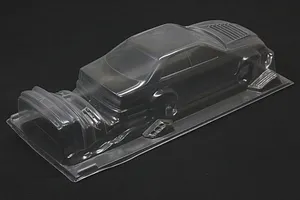 Unpainted clear polycarbonate RC car body shell for Toyota Mark II on a dark surface.