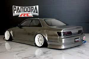 Rear-three-quarter studio view of a grey Pandora RC Toyota Mark 2 JZX100 drift body on a reflective surface.