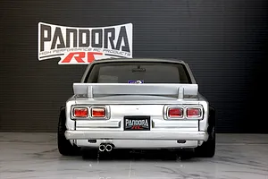 Rear view of a silver Pandora RC KPGC10 Skyline HT 2000GT-R drift body shell parked on a marble surface.
