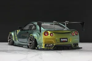 Rear three-quarter view of a custom-painted green and gold Pandora RC R35 GT-R RC drift car body with a large rear wing.