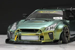 Low angle front view of a custom metallic green and gold RC drift car body styled after a Nissan R35 GT-R with BN-Sports kit.
