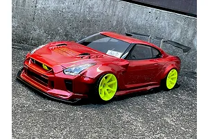 Custom painted red Pandora RC Nissan GT-R body shell mounted on an RC drift car with bright yellow wheels and a large rear wing.