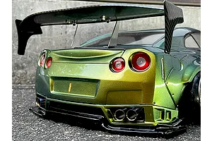 Rear view of an RC drift car body styled like a Nissan R35 GT-R with a color-shifting green and gold paint finish, large rear wing, and detailed exhaust tips.