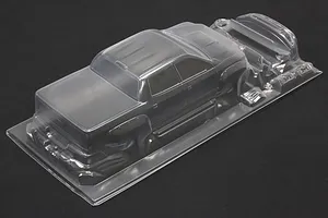 Unpainted clear polycarbonate RC truck body shell on a dark background.