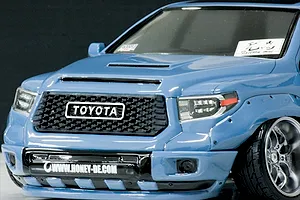 Close-up front view of the Pandora RC Toyota Tundra body shell painted blue with a detailed grille and custom wheels.