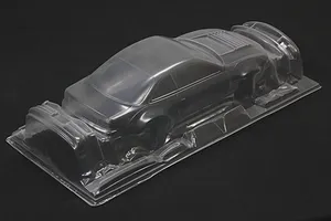 Unpainted clear polycarbonate RC car body shell for a Nissan Silvia S14 on a black background.