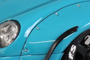 Close-up of the front fender and headlight of a blue Pandora RC RWB 993 model body shell.