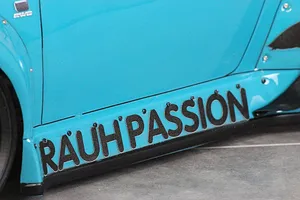 Close-up of the side skirt of a bright blue Pandora RC RWB 993 body shell featuring the text RAUH-PASSION.