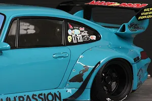 Close-up of the rear quarter section and window of a light blue Pandora RC RWB 993 body shell with decals.