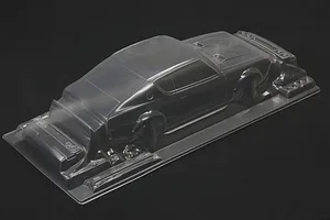 Unpainted clear polycarbonate RC car body shell on a black background, viewed from above and behind.