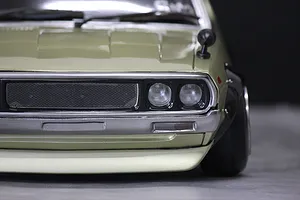 Close-up front view of the Pandora RC KPGC110 Skyline 2000GT-R Kenmeri body shell, showcasing the detailed grille, headlights, and fender mirror.