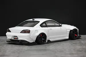 Rear-three-quarter view of a white RC drift car body shell mounted on a chassis, featuring wide fender flares and a Pandora RC license plate.