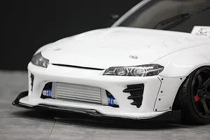 Close-up front angle of a white RC drift car body shell featuring a detailed front bumper, intercooler, and wide fenders.