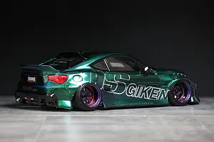 Rear-three-quarter view of a customized metallic green RC drift car body on a grey surface with a dark background.