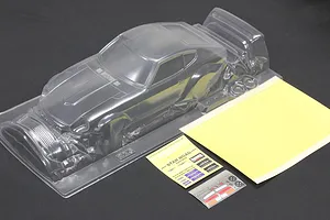 Unpainted clear polycarbonate Pandora RC S30 Fairlady Z body shell with decal sheets and masking film on a dark surface.