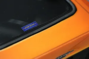 Close-up of the rear window and orange painted body of the Pandora RC S30 Fairlady Z Star Road body shell featuring a Star Road decal.