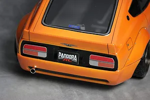 Close-up rear view of the Pandora RC S30 Fairlady Z Star Road body shell in metallic orange with realistic tail lights, exhaust, and decals.
