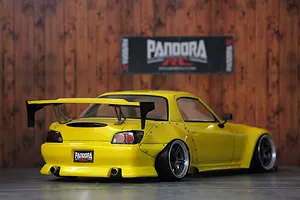 Rear three-quarter view of a yellow Honda S2000 RC drift car body shell with a large rear wing and Pandora RC branding.
