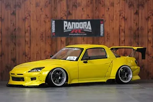 A painted yellow Honda S2000 RC drift car body shell on a studio display with wood background and Pandora RC banner.