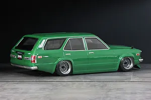 Rear-three-quarter view of a green Pandora RC Mazda RX-3 Savanna Sports Wagon body shell on display with custom mesh wheels.