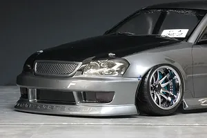 Close-up front quarter view of a grey RC drift car body with carbon hood, chrome wheels, and BN-Sports branding.