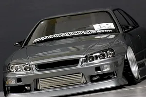 Low angle front view of a grey ER34 Skyline RC drift car body with low stance, intercooler, and windshield decals.