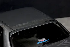 Close-up of the grey RC car body roof, rear window, and roof spoiler with Pandora RC and Toyo Tires decals.