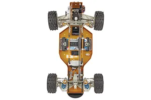 Top down studio view of the Team Associated RC10 4WD buggy chassis showing the gold anodised aluminum plate and internal chain drive.