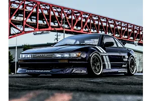 Kyosho Fazer D2 Nissan S13 Silvia RC drift car in purple parked outdoors with a large red bridge in the background.