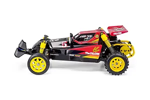 Side view of Tamiya The Falcon 1/10 scale electric 2WD RC buggy featuring black and red body, yellow wheels, and yellow shock absorbers against a white background.