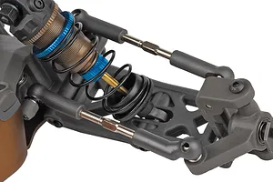 Close-up studio view of the front suspension, threaded alloy shock, and adjustable turnbuckles on an RC buggy model.
