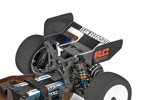 Close-up studio shot of the rear suspension, wing, and battery area of the Team Associated RC buggy.