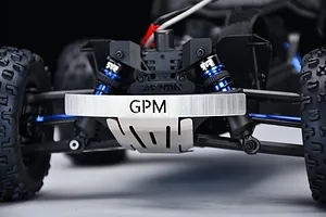 Close-up front view of an RC car chassis installed with a GPM silver stainless steel front skid plate featuring the GPM logo.