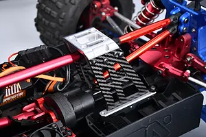 GPM carbon fibre and aluminium centre tower brace installed on an RC car chassis with red and blue components.