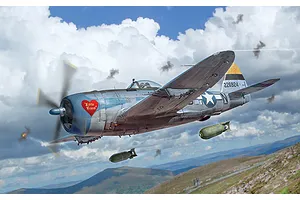 Box art painting of a P-47D Thunderbolt fighter aircraft in flight dropping bombs over a mountainous landscape with cloudy skies.