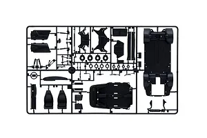 Black plastic model kit parts sprue containing chassis, interior components, seats, and suspension parts.