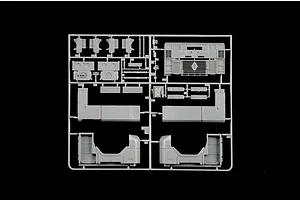 Grey plastic model kit parts sprue featuring truck parts and chassis components against a black background.